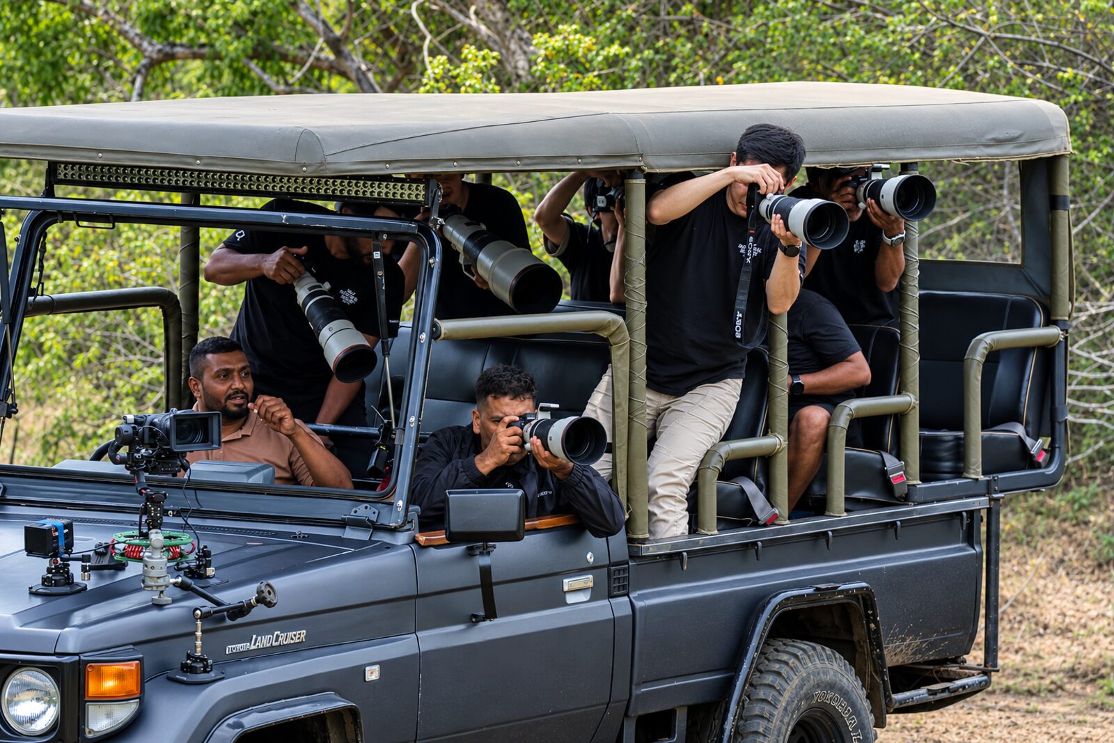 Photographers with long lenses on a Yala Safari LK vehicle